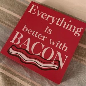 Red wall decor “Everything’s better with bacon”.